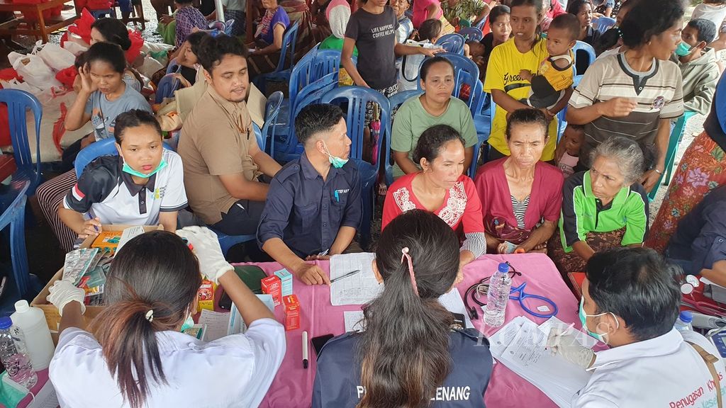 Warga Desa Golo Wune, Kabupaten Manggarai Timur, Nusa Tenggara Timur, mengantre untuk pemeriksaan kesehatan oleh petugas puskesmas saat kunjungan Menteri Sosial Tri Rismaharini pada Minggu (25/2/2024).