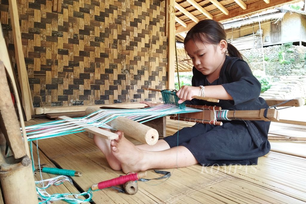 Mika (6) asal Kampung Marengo, Baduy Luar, belajar membuat tenun ikat kepala, Kamis (27/10/2022).