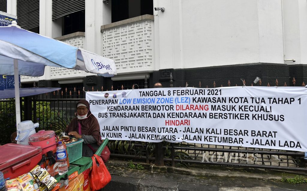 Informasi penerapan zona rendah emisi (<i>low emission zone</i>) di kawasan Kota Tua, Jakarta Barat, terpasang di depan salah satu bangunan, Jumat (5/8/2021). Penerapan zona rendah emisi mulai diberlakukan pada Senin (8/2/2021). Namun, implementasinya hingga kini tidak berjalan. 