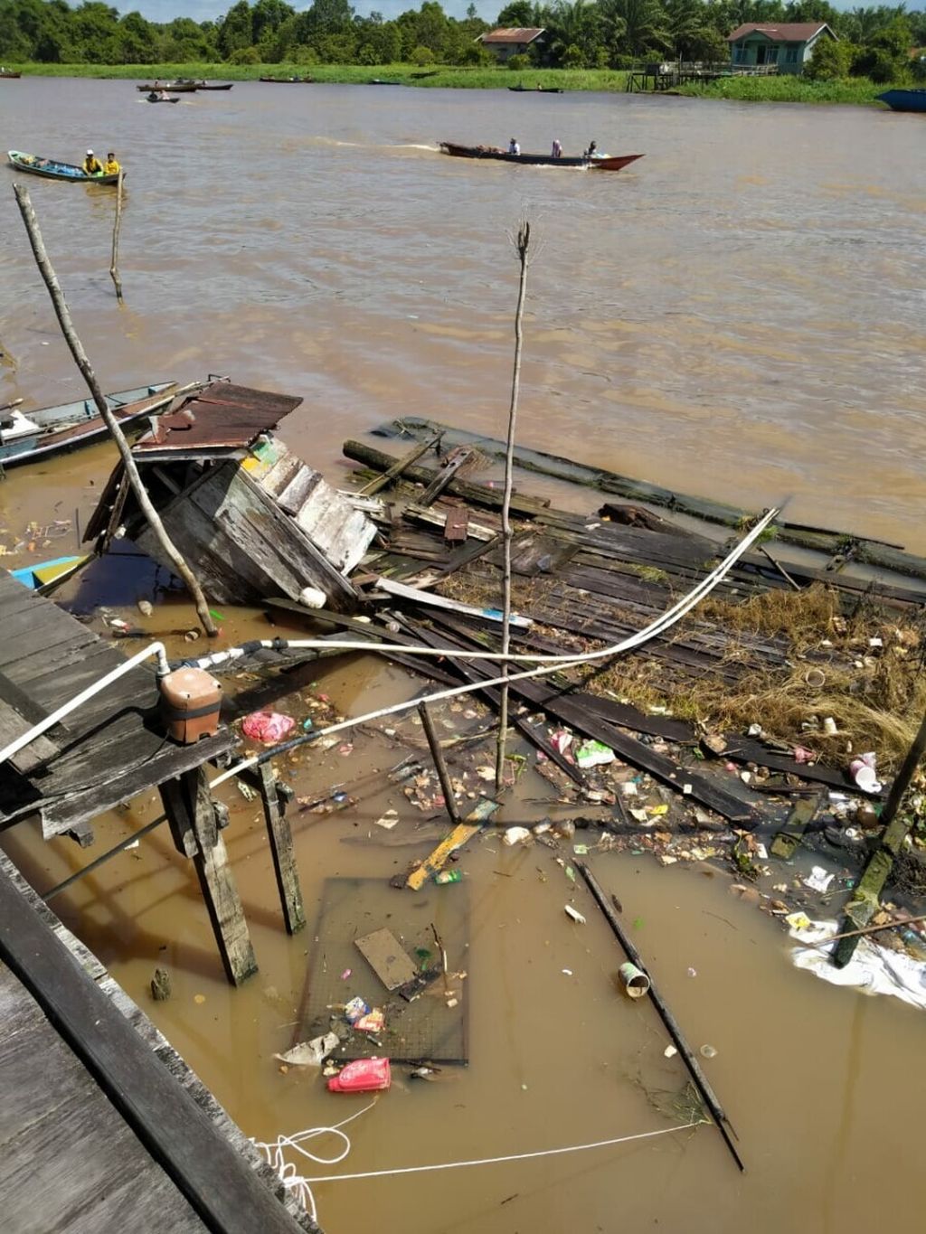 Sebuah rumah lanting atau rumah apung yang rusak dan tenggelam lantaran ledakan yang terjadi pada tongkang yang ditambat tak jauh dari rumah itu, di Sungai Arut, Kabupaten Kotawaringin Barat, Kalimantan Tengah, Senin (5/7/2021).