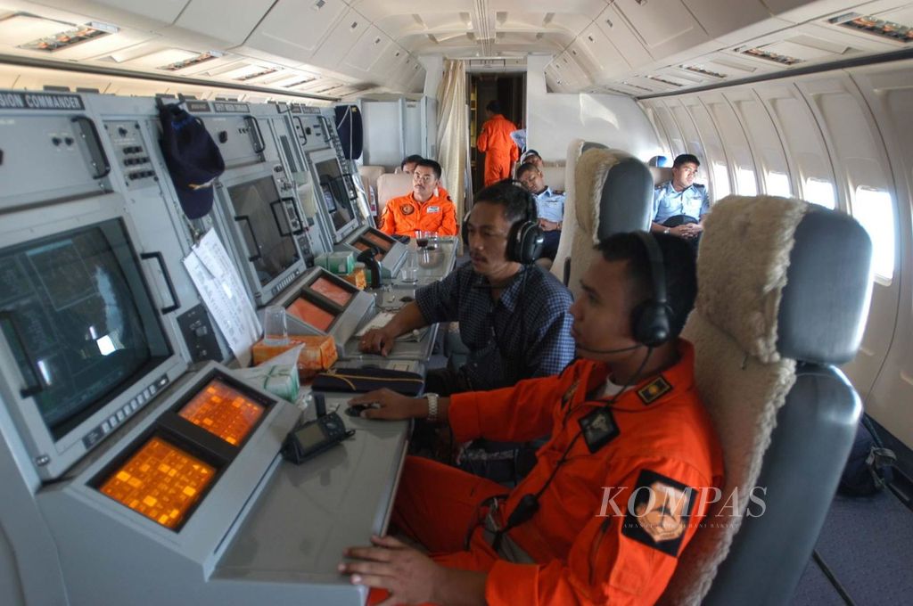 Seorang perwira TNI AU dalam overall oranye mengoperasikan radar intai di perut pesawat intai Boeing 737-200, (3/12/2004). Radar tersebut mampu menjejak sasaran dalam wilayah seluas 200 mil laut.