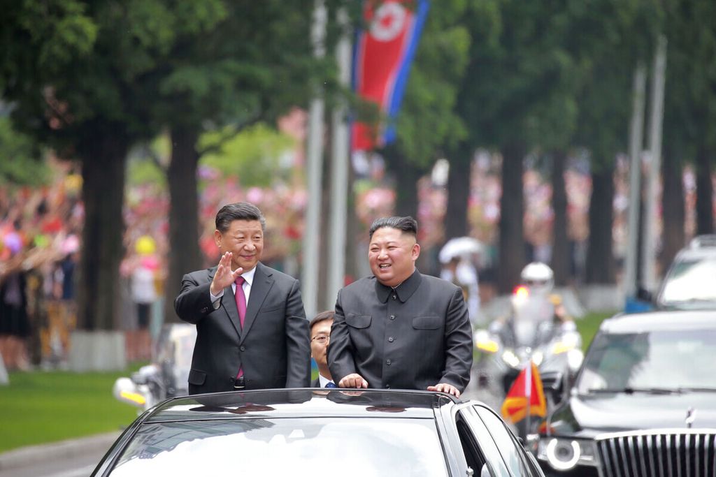  Gambar 20 Juni 2019 yang dirilis oleh kantor berita resmi Korea Utara, KCNA, pada 21 Juni 2019 memperlihatkan Pemimpin Korea Utara Kim Jong Un (kanan) dan Presiden Cina Xi Jinping melambaikan tangan kepada orang banyak setelah kedatangannya di Pyongyang, Korut. 
