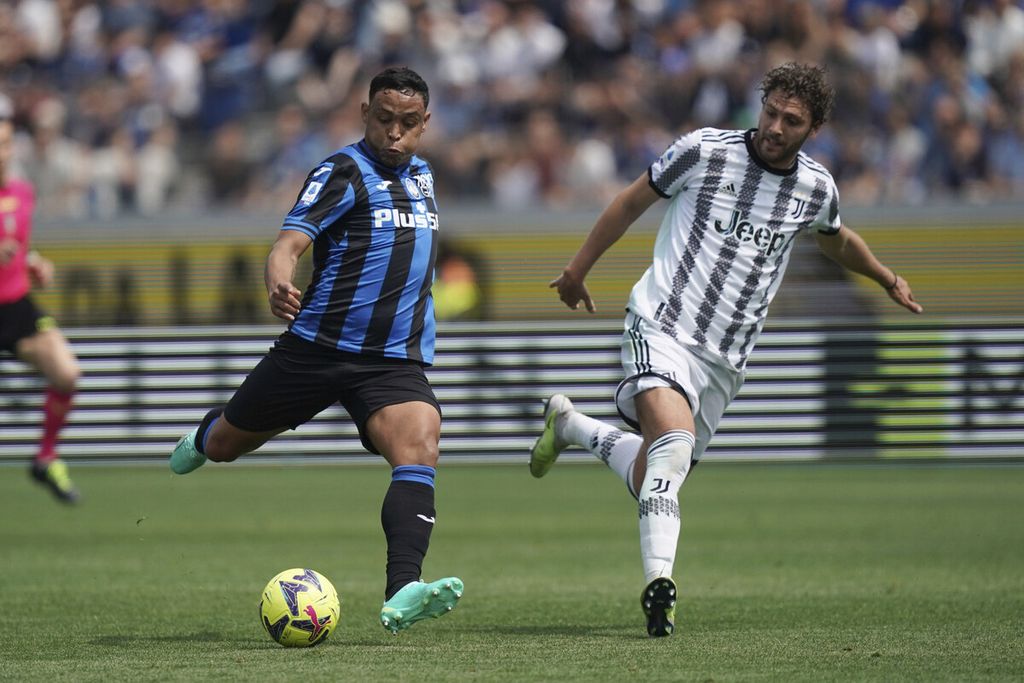 Pemain Atalanta, Luis Muriel (kiri), menendang bola disaksikan pemain Juventus, Manuel Locatelli, dalam pertandingan Liga Italia antara Atalanta dan Juventus di Stadion Gewiss, Bergamo, Italia, Minggu (7/5/2023). Juventus mengalahkan tuan rumah, 2-0. 