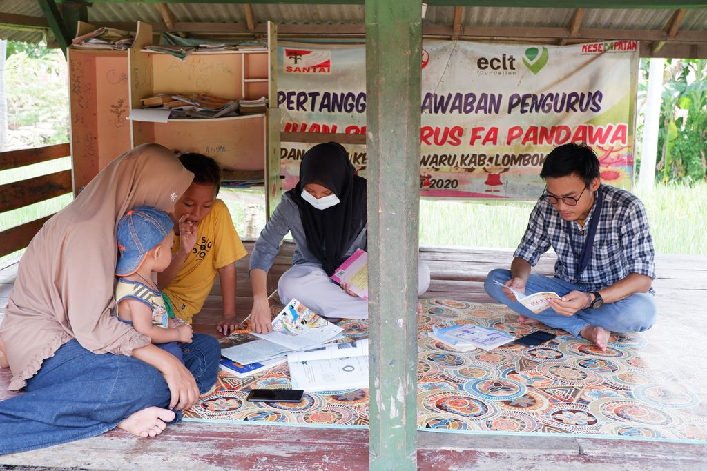 Anak-anak pekerja migran menghabiskan waktu dengan membaca buku di Sekretariat Forum Anak Pandan Wangi di Desa Pandan Wangi, Kecamatan Jerowaru, Kabupaten Lombok Timur, Nusa Tenggara Barat, Rabu (3/3/2021). Forum itu aktif mendorong pemenuhan hak-hak anak pekerja migran di desa tersebut.