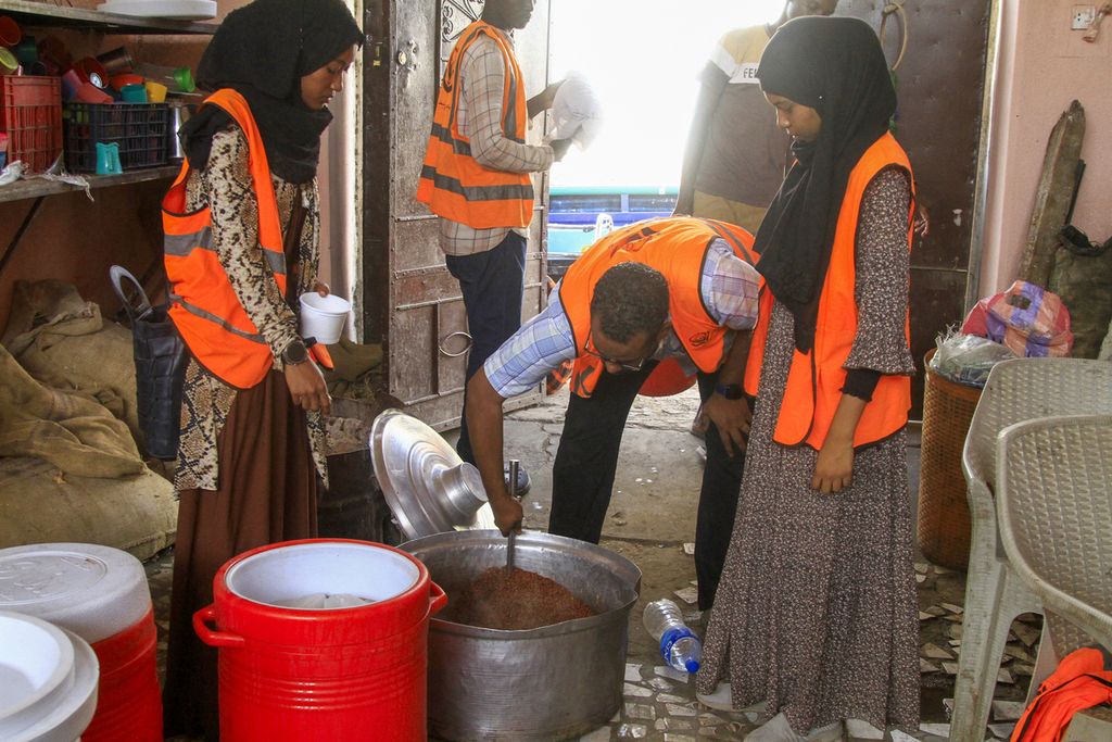Sukarelawan menyiapkan makanan bagi umat Islam yang mengungsi untuk berbuka puasa selama bulan suci Ramadhan di Gedaref, Sudan, 13 Maret 2024. Perang Sudan meletus pada April 2023 antara tentara dan Pasukan Dukungan Cepat (RSF), membuat sebagian warga kesulitan makanan.