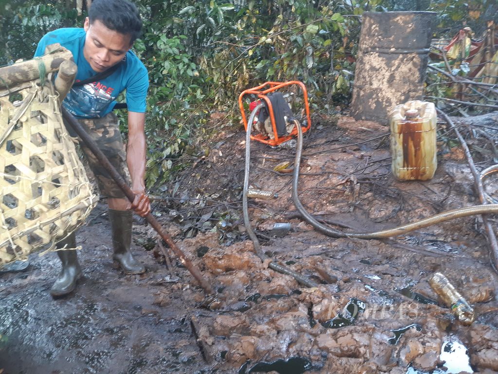 Suasana di area tambang minyak ilegal di Kelurahan Keluang, Kecamatan Keluang, Kabupaten Musi Banyuasin, Sumatera Selatan, Jumat (16/9/2022). Semburan minyak yang berlangsung sejak Rabu (14/9/2022) membuat area itu dipenuhi minyak mentah. Warga pun berbondong-bondong mengais minyak.