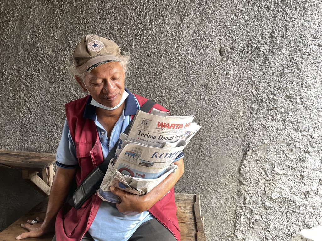 Rahmad (53) berjualan koran dengan berkeliling Pasar Jatinegara, Jakarta Timur, Minggu (10/10/2021). 