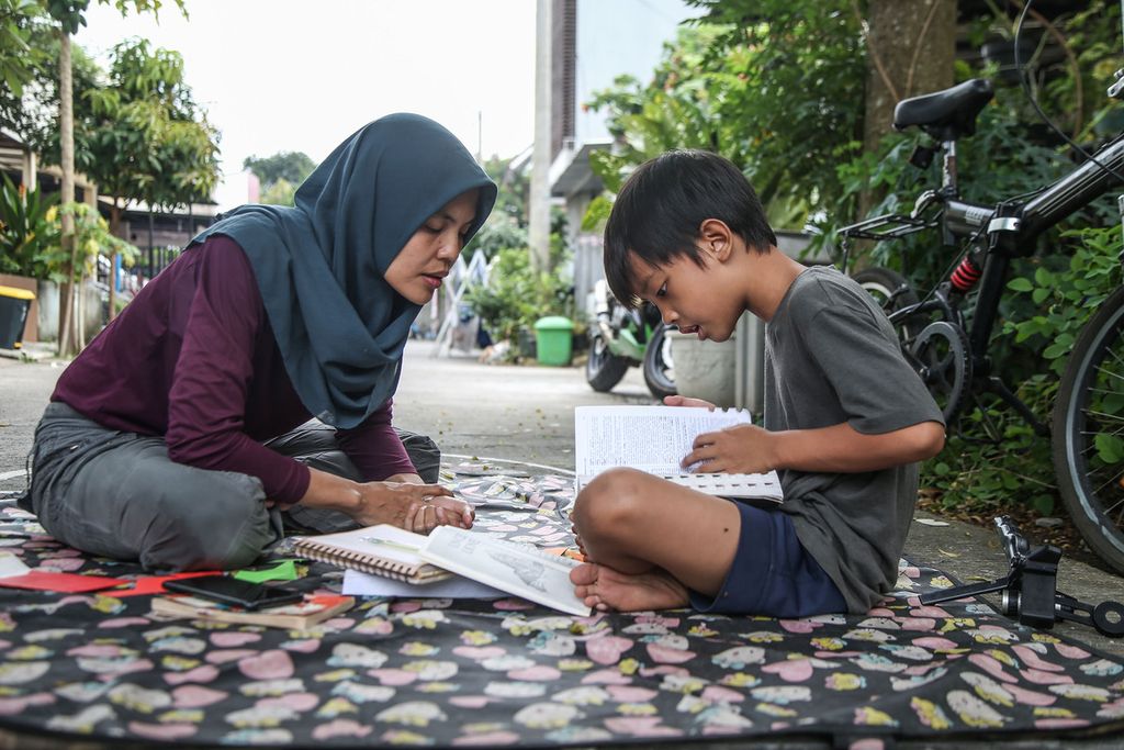 Makki Ken (8), belajar membuat narasi novel yang dibacakan ibunya Asrie Nadya (38), di rumahnya di kawasan Pondok Benda, Tangerang Selatan, Banten, Jumat (19/3/2021). Keluarga Asrie Nadya memilih mendidik anak-anaknya di rumah dengan metode sekolahrumah (<i>home schooling</i>) daripada di sekolah formal.