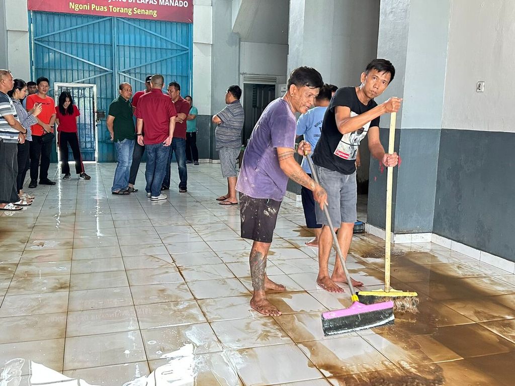 Warga binaan Lembaga Pemasyarakatan Kelas IIA Manado membersihkan lantai satu fasilitas pemasyarakatan itu, Minggu (29/1/2023), pascabanjir yang melanda Manado, Sulawesi Utara. Sebanyak 180 dari total 358 warga binaan menghuni lantai satu.