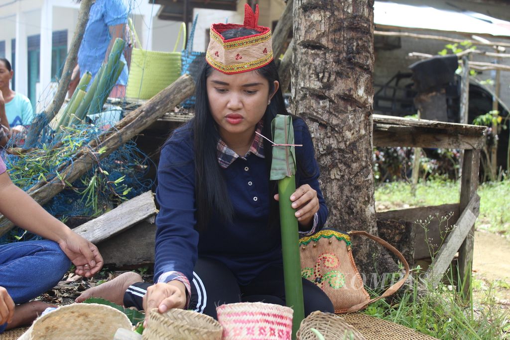 Salah satu warga Desa Riam Tinggi, Kecamatan Delang, Kabupaten Lamandau, Kalteng menyiapkan bambu yang sudah diisi beras untuk membuat nasi lemang, pada Minggu (26/2/2023). Saat itu warga sedang memasak dalam memeriahkan Festival Kampung Riam Tinggi.