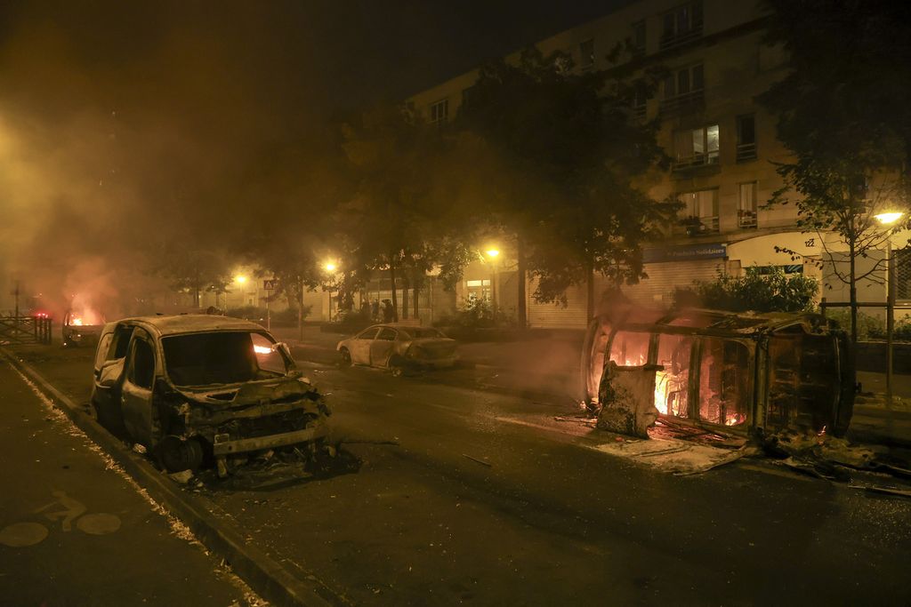 Mobil-mobil terbakar pada hari ketiga aksi unjuk rasa yang disertai kerusuhan massal di pinggiran Paris, Perancis (30/6/2023). Penembakan remaja Nahel oleh polisi memicu bentrokan antara polisi dan warga.