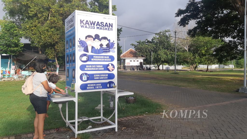 Wisatawan mencuci tangan di fasilitas yang telah disediakan pengelola Pantai Boom Marina Banyuwangi, Rabu (15/8/2020). 