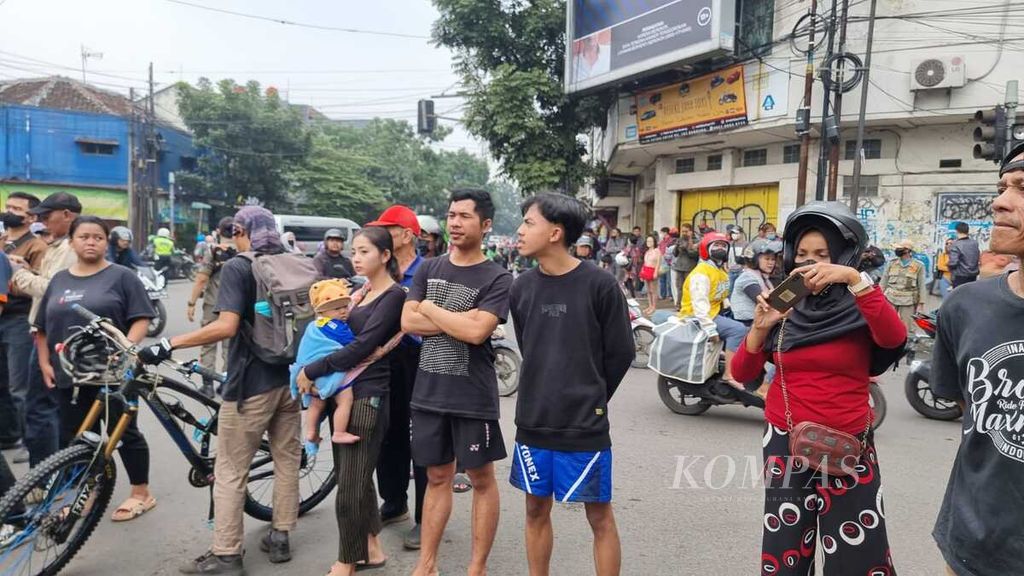 Warga berkerumun di luar garis pengaman lokasi ledakan bom di Polsek Astanaanyar, Kota Bandung, Jawa Barat, Rabu (7/12/2022). Dua orang tewas, salah satunya pelaku bom bunuh diri. 