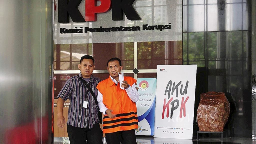Panitera pengganti PN Jakarta Selatan Tarmizi (kanan) seusai menjalani pemeriksaan perdana meninggalkan gedung Komisi Pemberantasan Korupsi (KPK), Jakarta, Rabu (23/8/2017), dengan mengenakan rompi tahanan. KPK. 