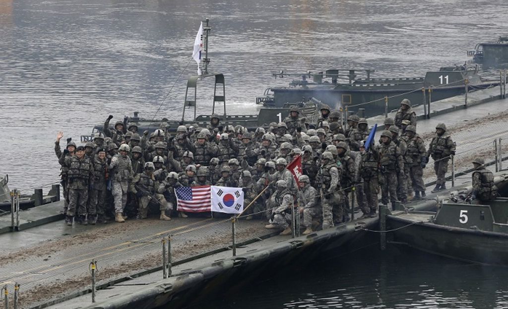 Foto yang diambil pada 10 Desember 2015 ini menunjukkan saat tentara AS dan Korea Selatan berpose di atas jembatan mengambang di Sungai Hantan setelah operasi penyeberangan sungai, bagian dari latihan militer gabungan tahunan antara Korsel dan AS terhadap kemungkinan serangan dari Korea Utara, di Yeoncheon.