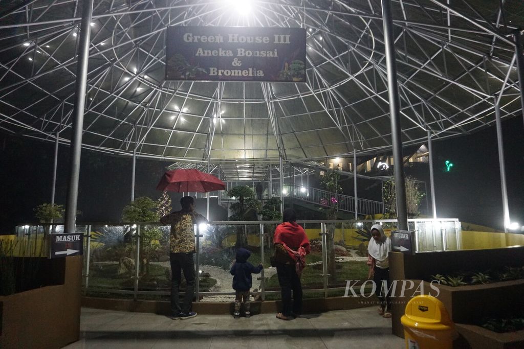 Pengunjung melihat aneka tanaman di Taman Botani Baturraden, Banyumas, Jawa Tengah, Minggu (25/12/2022) malam.