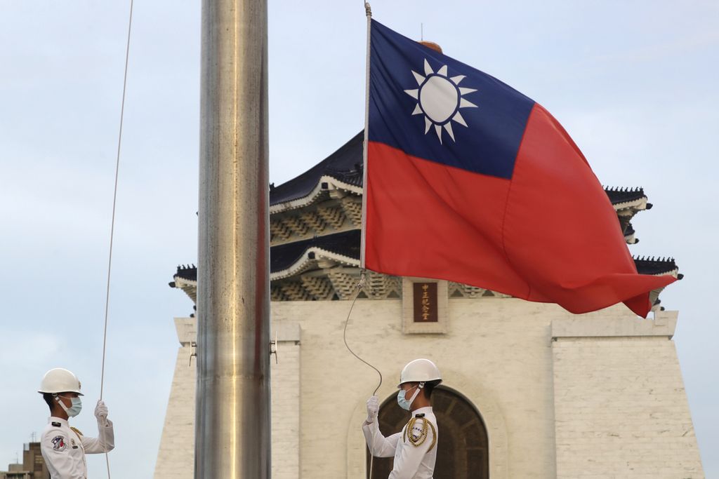 Dua tentara Taiwan menaikkan bendera nasional dalam upacara pengibaran di Lapangan Kebebasan di Monumen Chiang Kai-shek di Taipei, Taiwan, 30 Juli 2022. 