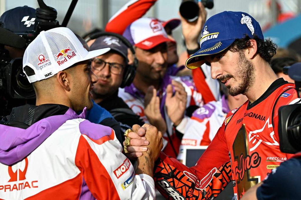 Pebalap Ducati Lenovo, Francesco Bagnaia (kanan), dan pebalap Prima Pramac Racing, Jorge Martin, berjabat tangan setelah balapan utama MotoGP seri Valencia di Sirkuit Ricardo Tormo, Cheste, Spanyol, Minggu (26/11/2023). Bagnaia berhasil menjadi juara dunia MotoGP 2023. 