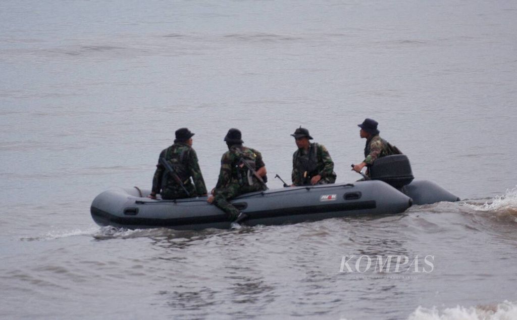 Personel medis Korps Marinir menumpang perahu karet bermotor meninggalkan Pantai Banongan, Situbondo, Sabtu (2/2/2008). 