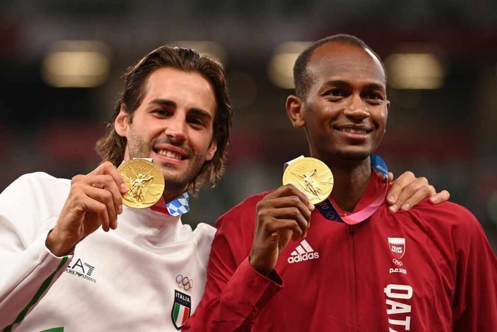 Atlet loncat tinggi Italia, Gianmarco Tamberi, dan atlet loncat tinggi Qatar, Mutaz Essa Barshim, berpose dengan medali emas masing-masing setelah final lompat tinggi putra Olimpiade Tokyo 2020 di Stadion Olimpiade, Tokyo, Jepang, 2 Agustus 2021.