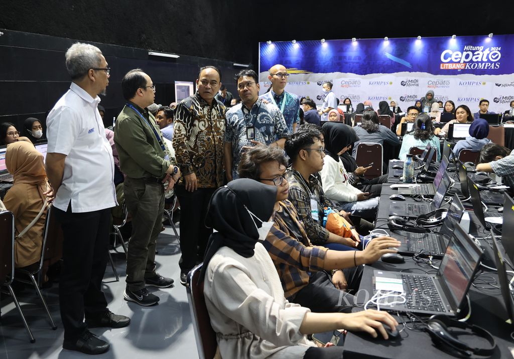 Menteri Komunikasi dan Informatika Republik Indonesia Budi Arie Setiadi (Berdiri ketiga kiri) dan Dirjen Informasi dan Komunikasi Publik Usman Kansong (kiri) saat berkunjung ke War Room Hitung Cepat <i>Kompas</i> di Menara Kompas, Senin (12/2/2024). 
