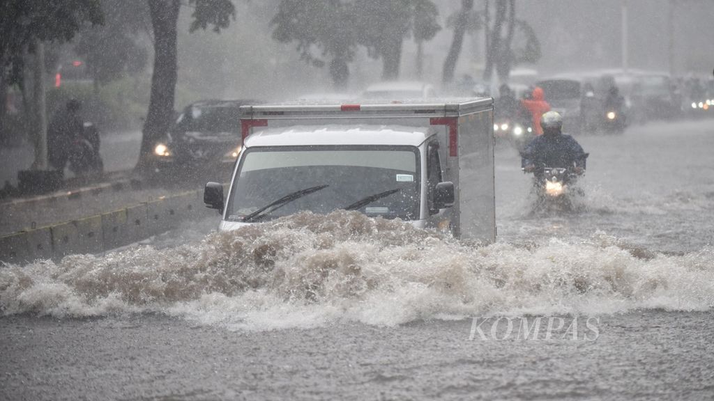 Pengendara berupaya menerobos banjir yang menggenangi Jalan Sultan Iskandar Muda, Kebayoran Lama, Jakarta Selatan, Jumat (9/10/2020). 