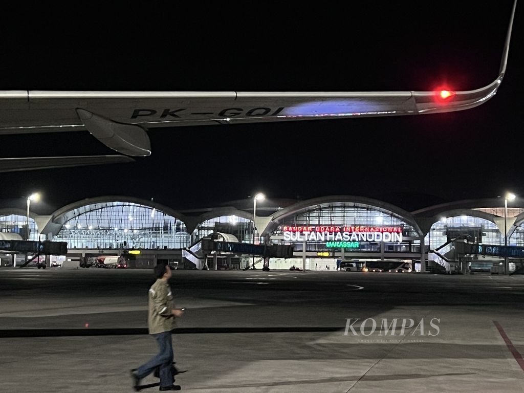 Seorang petugas melintas di bawah pesawat di Bandara Internasional Sultan Hasanuddin, Makasaar, Rabu (22/5/2024).