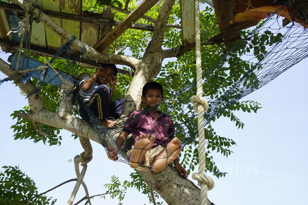 Anak-anak bermain di atas pohon di tepi pantai Desa Tanjung Aru, Kecamatan Sebatik Timur, Kabupaten Nunukan, Kalimantan Utara, pada Agustus 2019.