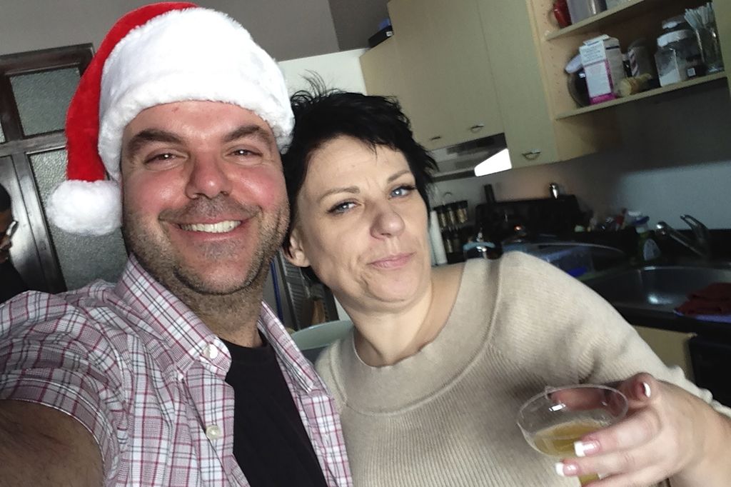 Johnathan Walton (left), one of Marianne "Mair" Smyth's fraud victims, poses for a photo with Smyth at a Christmas party in downtown Los Angeles, United States, in December 2013.