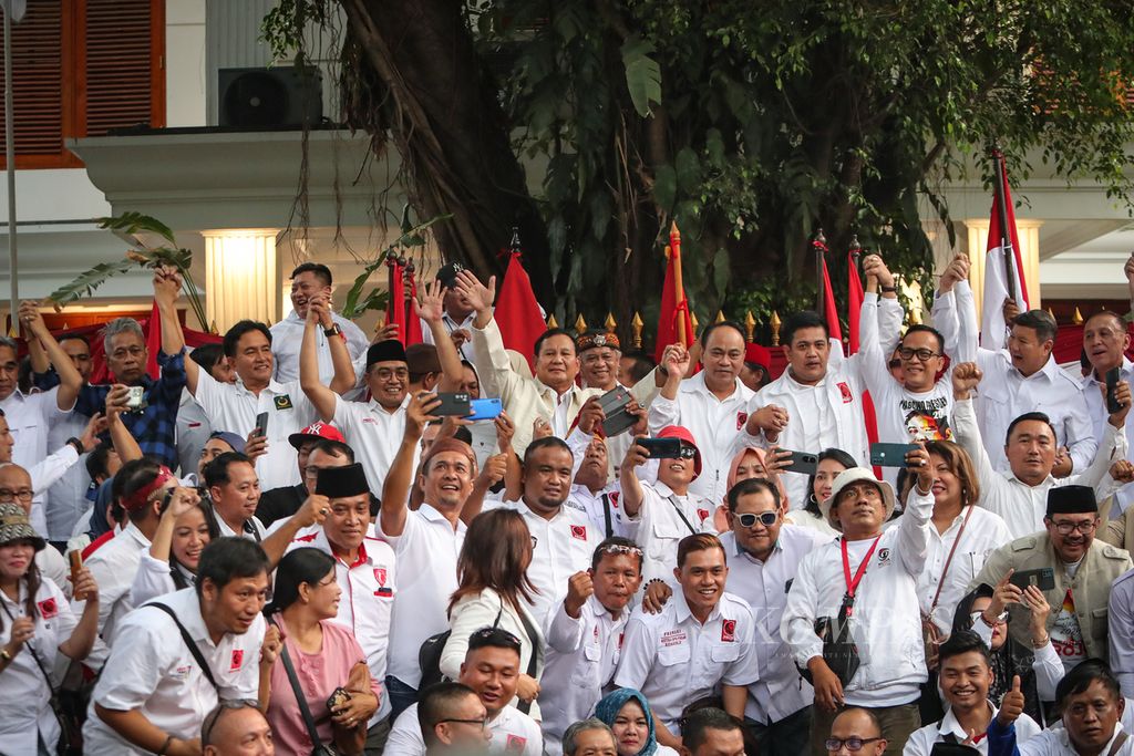 Bakal calon presiden dari Partai Gerindra, Prabowo Subianto (melambaikan tangan), berfoto bersama sukarelawan Projo di Jalan Kertanegara, Jakarta, Sabtu (14/10/2023). Projo resmi mendukung Prabowo Subianto dalam Pemilihan Presiden 2024 setelah membuka Rakernas VI yang berlangsung pada 14-15 Oktober 2023.  