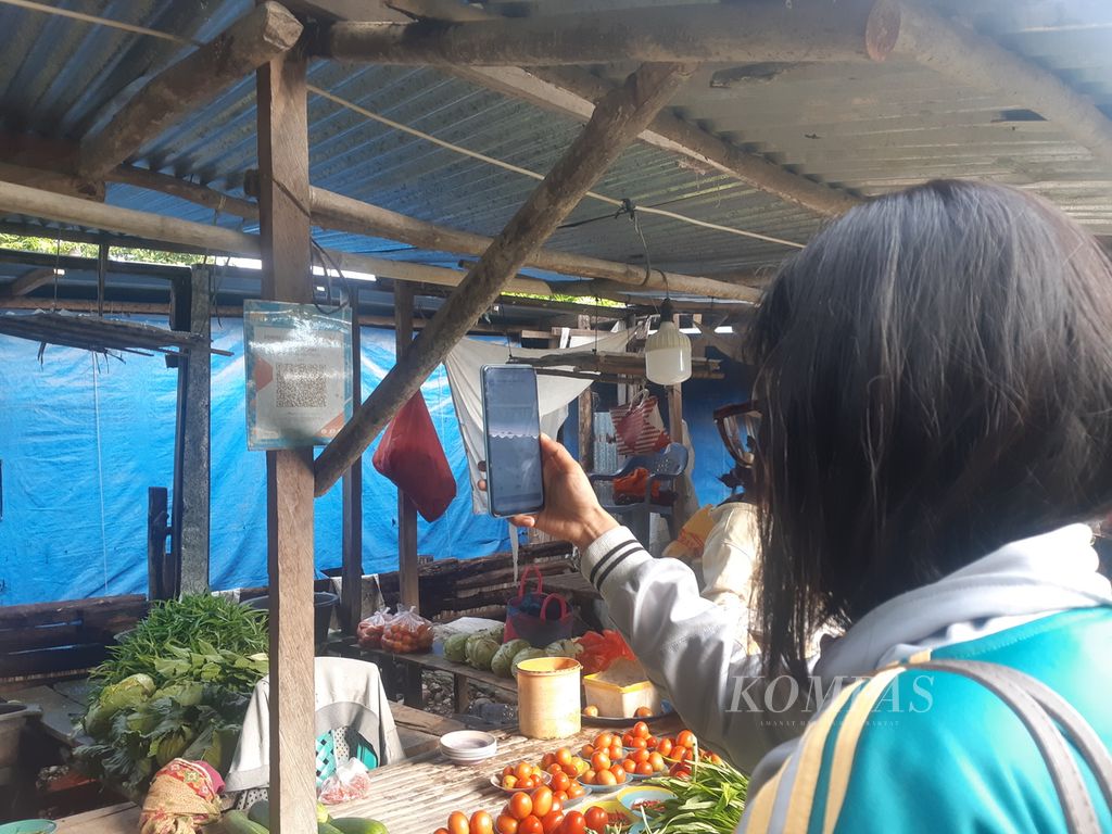 Pengunjung membeli sayur dengan QRIS di pasar tradisional Betun, Kabupaten Malaka, Nusa Tenggara Timur. Hingga Februari 2023, metode tersebut semakin banyak ditemukan di sana.