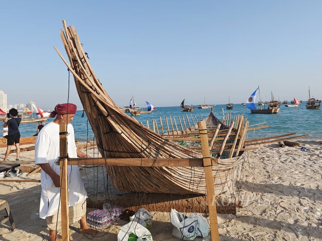 Hassan, nelayan asal Oman, tengah mengamati kapal kayunya yang masih proses pembuatan di Pantai Katara, Doha, Qatar, Selasa (6/12/2022). Selain aktivitas melaut, para nelayan di Katara juga menjajakan hasil tangkapan ikan dan hasil olahan kerang laut yang menjadi hiasan rumah.
