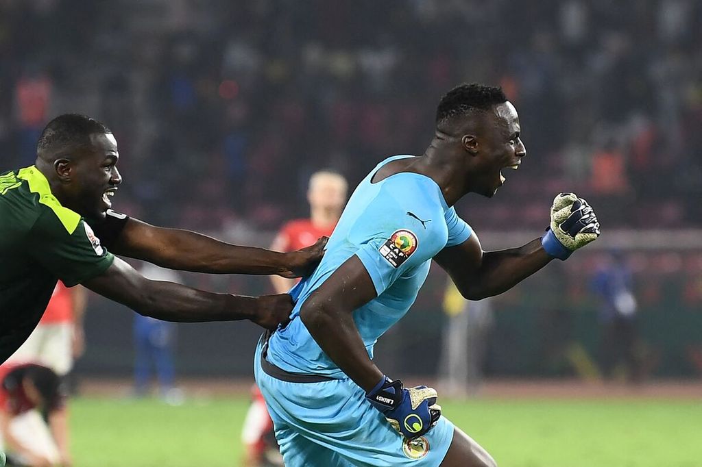 Kiper timnas Senegal, Edouard Mendy (kanan), merayakan kemenangan usai adu penalti melawan Mesir pada final Piala Afrika, Minggu (6/2/2022), di Stadion dOlembe, Yaounde, Kamerun. 