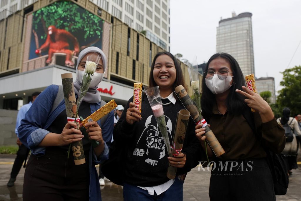 Warga menerima bunga yang dibagikan oleh Tim Kampanye Nasional Pemilih Muda Prabowo-Gibran di perempatan Sarinah, Jakarta, Kamis (15/2/2024). Aksi ini digelar sebagai bentuk terima kasih atas kemenangan pasangan capres-cawapres nomor urut 2 di Pilpres 2024 versi hitung cepat. 