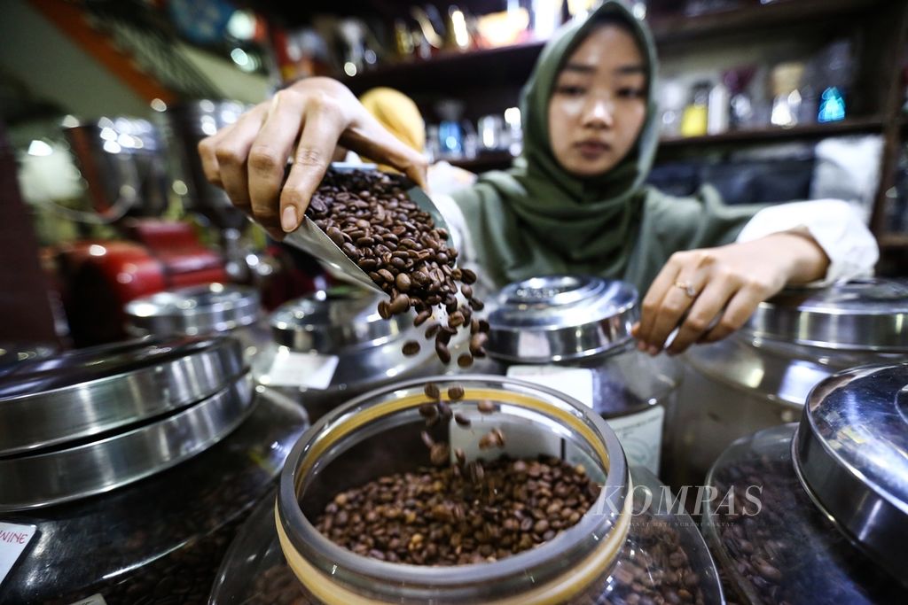 Pedagang memperlihatkan biji kopi yang dijual di kios Dunia Kopi Pasar Santa, Jakarta Selatan, Jumat (15/11/2019). Kopi merupakan salah satu komoditas ekspor Indonesia.