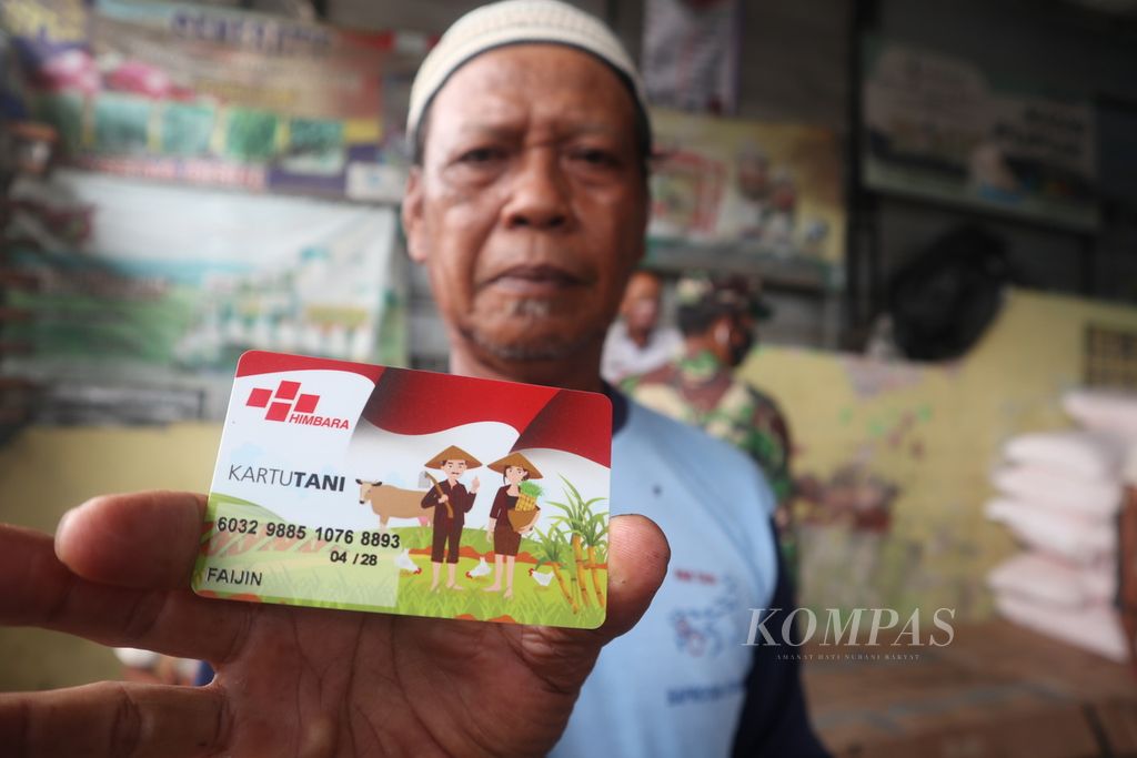 Petani menunjukkan kartu tani di sebuah kios di Kecamatan Panguragan, Kabupaten Cirebon, Jawa Barat, Rabu (6/1/2021). Meskipun telah memiliki kartu tani, petani mengeluh belum bisa membeli pupuk subsidi karena jumlahnya sedikit.