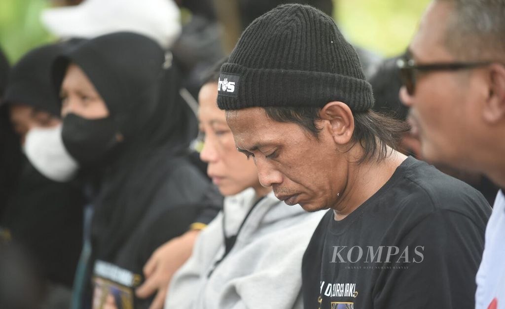 Ayah dari dua korban Tragedi Kanjuruhan, yaitu NDR (16) dan NDB (13), yang jasadnya diotopsi, Devi Athok, berada di Tempat Pemakaman Umum (TPU) Dusun Patuk, Desa Sukolilo, Kecamatan Wajak, Kabupaten Malang, Jawa Timur, Sabtu (5/11/2022). 