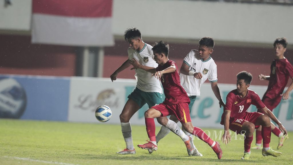 Indonesia and Vietnam U-16 players chase the ball in the U-16 AFF Cup final at Maguwoharjo Stadium, Sleman, DI Yogyakarta, Friday (12/8/2022).