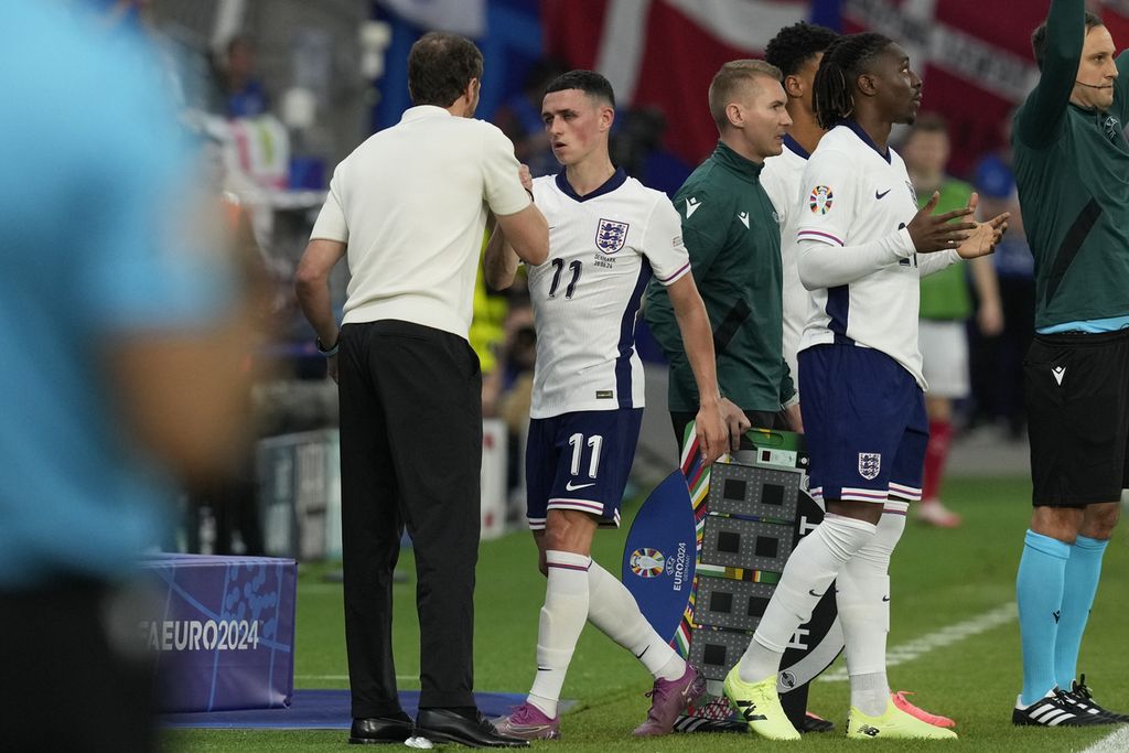 Phil Foden dari Inggris, kedua dari kiri, berjabat tangan dengan Manajer Gareth Southgate setelah digantikan pada pertandingan Grup C antara Denmark dan Inggris pada turnamen sepak bola Piala Eropa 2024 di Frankfurt, Jerman, Kamis, 20 Juni 2024.