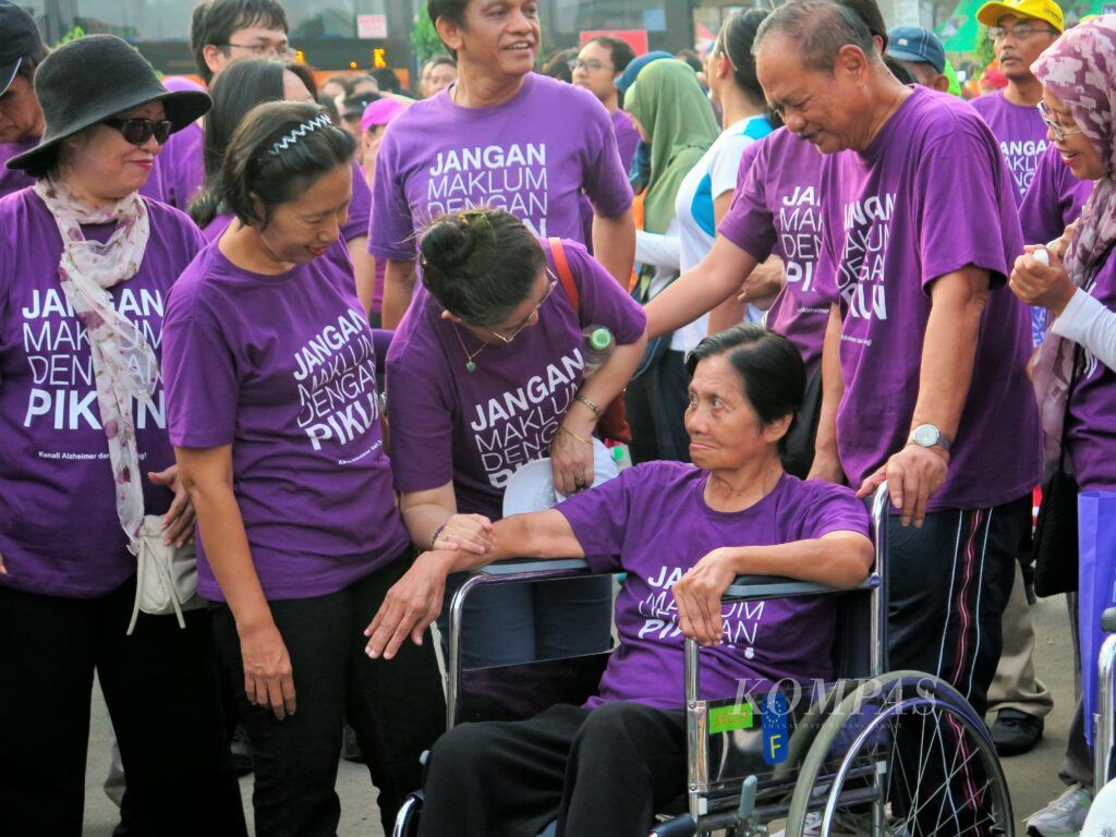Ibu dengan demensia alzheimer, Tien Suharya, mengikuti kegiatan Jalan Sehat Peduli Alzheimer di Jakarta, Minggu (21/9/2014). Tien ditemani suaminya, Yaya Suharya.