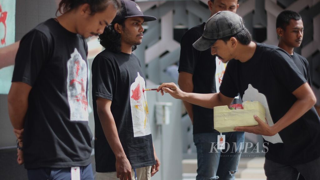 Iskandar, Ketua Laboratorium Seni Aceh Rakitan, saat melakukan demo sketsa ornamen Aceh pada kaos panitia saat pembukaan Festival Ornamen Aceh di Museum Tsunami Aceh, Banda Aceh, Sabtu (10/6/2023). Ada ratusan ornamen Aceh yang dipamerkan dalam festival itu sebagai bentuk kampanye melestarikan kekayaan kesenian Aceh.