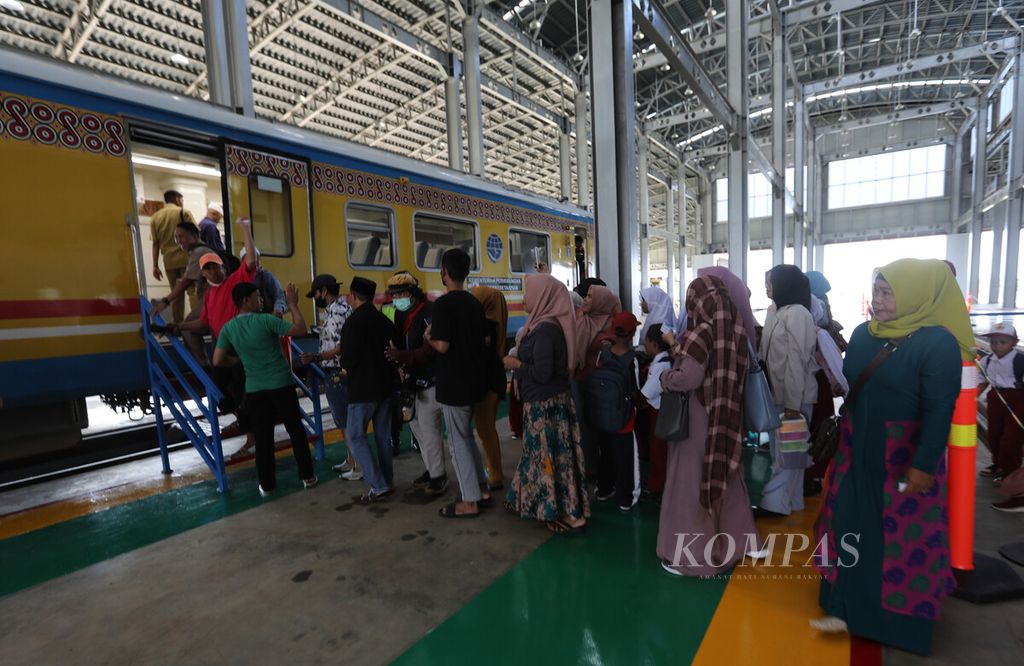 Calon penumpang memasuki rangkaian kereta luar biasa di Depo Kereta Maros, Sulawesi Selatan, untuk mengikuti perjalanan uji coba rute Maros-Garongkong yang menjadi fase awal dari proyek jalur kereta Makassar-Parepare, Selasa (10/1/2023). 