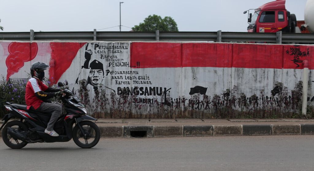 Warga melintas di depan mural kemerdekaan di Pulo Gebang, Jakarta Timur, Senin (18/5/2020). Pesan-pesan pendiri bangsa menghiasi sudut kota untuk mengingatkan kepada anak cucu perjuangan harus terus diteruskan. 