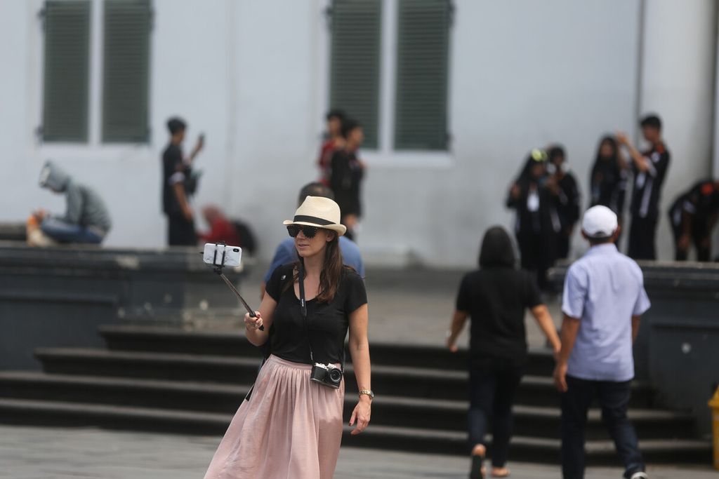 Wisatawan mancanegara membuat vlog di Lapangan Museum Fatahillah, Kota Tua, Jakarta Barat, Senin (20/1/2020).