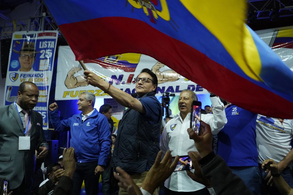 Calon presiden Ekuador, Fernando Villavicencio, mengayunkan bendera Ekuador ketika berkampanye di Quito pada 9 Agustus 2023. Tidak lama setelah itu, ia ditembak mati saat meninggalkan gedung kampanye.