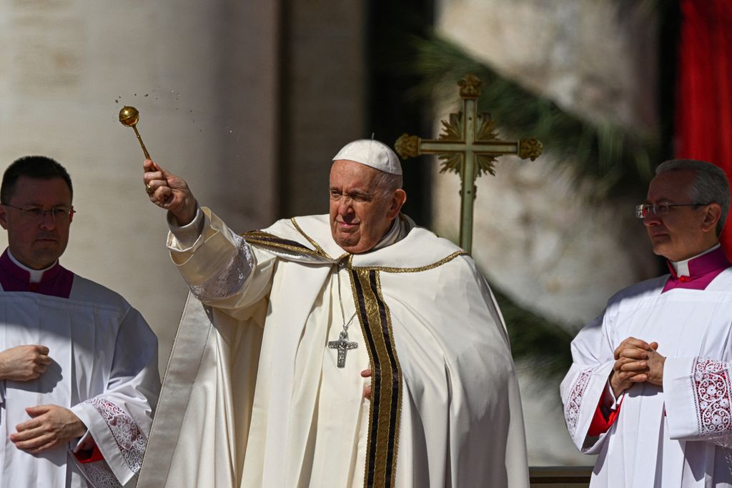 Pope Francis sprinkles attendees with water during the Easter Sunday mass on April 9, 2023 at St. Peter's square in The Vatican, as part of celebrations of the Holy Week. 