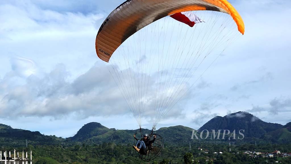 Peserta atraksi wisata paramotor melayang di udara di Takengon, Aceh Tengah, Provinsi Aceh, Sabtu (15/9/2018).