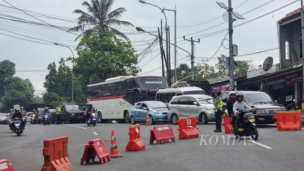 Petugas menutup ruas jalan menuju Limbangan, Garut, di jalur Nagreg, Kabupaten Bandung, Jawa Barat, Rabu (19/4/2023). Penutupan sementara waktu ini dilakukan untuk mengurai kemacetan di sekitar Limbangan.