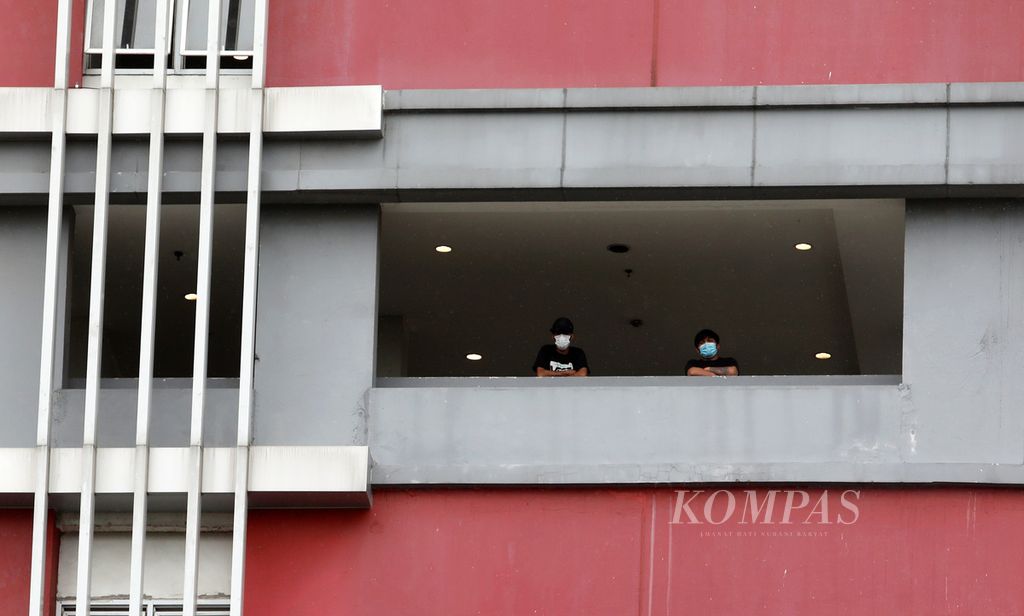 Pasien Covid-19 berdiri di balkon salah satu menara di Wisma Atlet Pademangan, Jakarta Utara, Kamis (21/1/2021). 