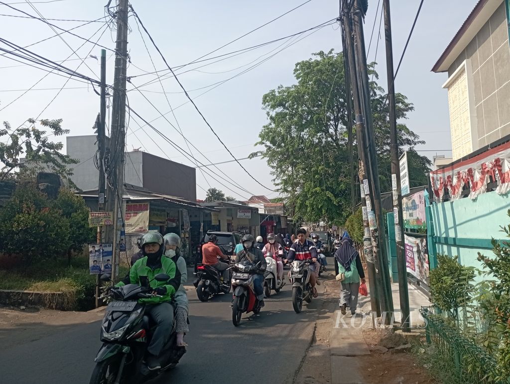 Sejumlah pengendara kendaraan bermotor menggunakan rute alternatif saat hendak melewati Jalan Ceger Raya, Pondok Aren, Tangerang Selatan, Senin (4/9/2023).